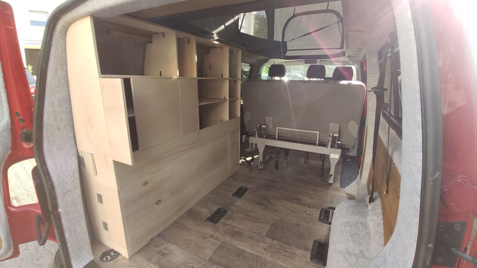 T6 interior during the conversion, with a handmade wooden cabinet and bench seat