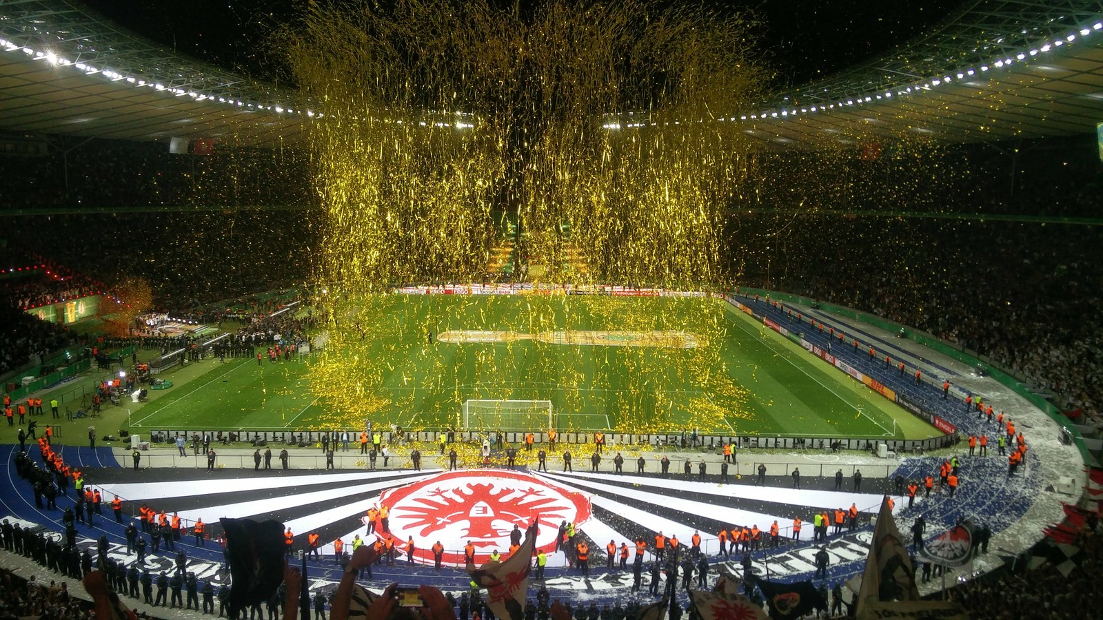 Golden confetti and a large Eintracht flag after winning the cup in Berlin